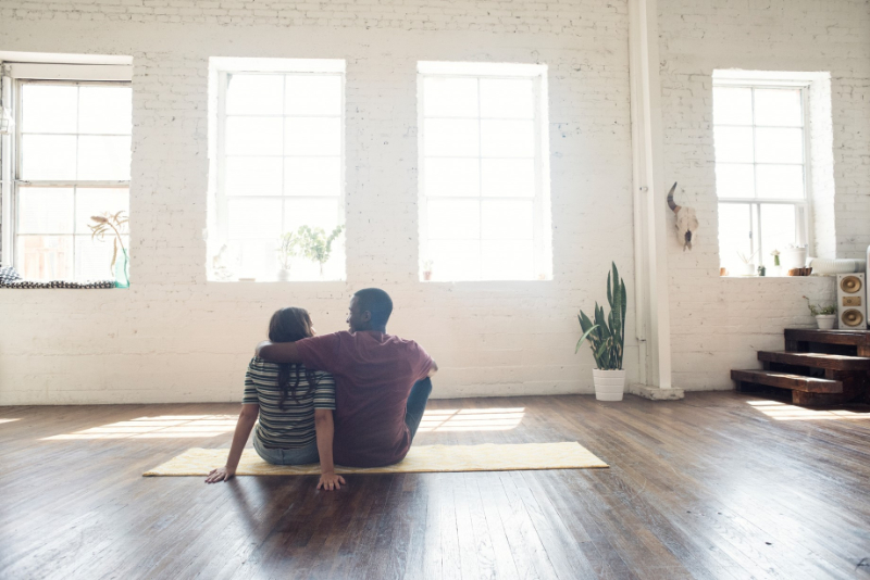 Couple sitting on their home